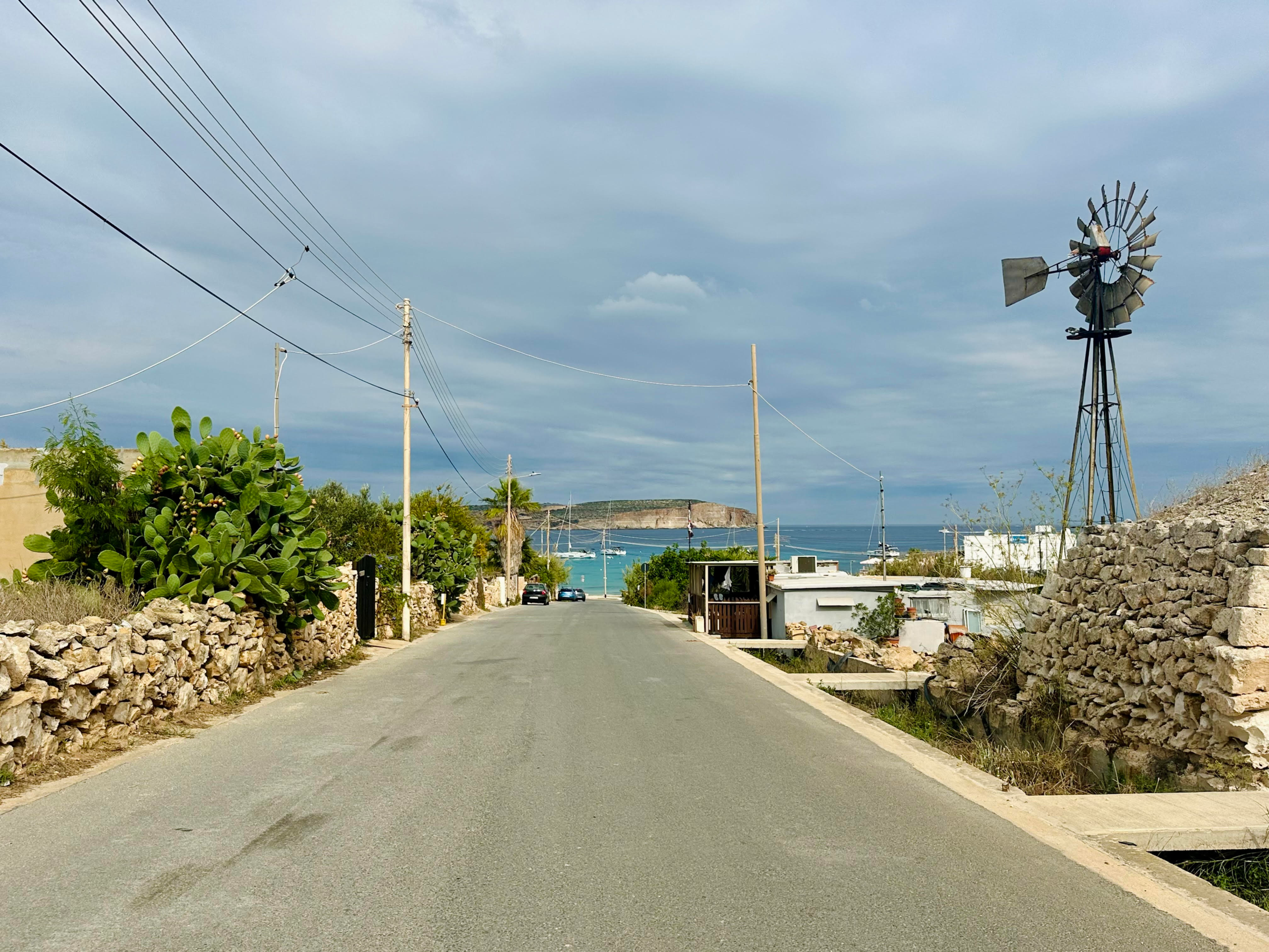 Driving along Malta’s coastal roads with the Mediterranean Sea in view.