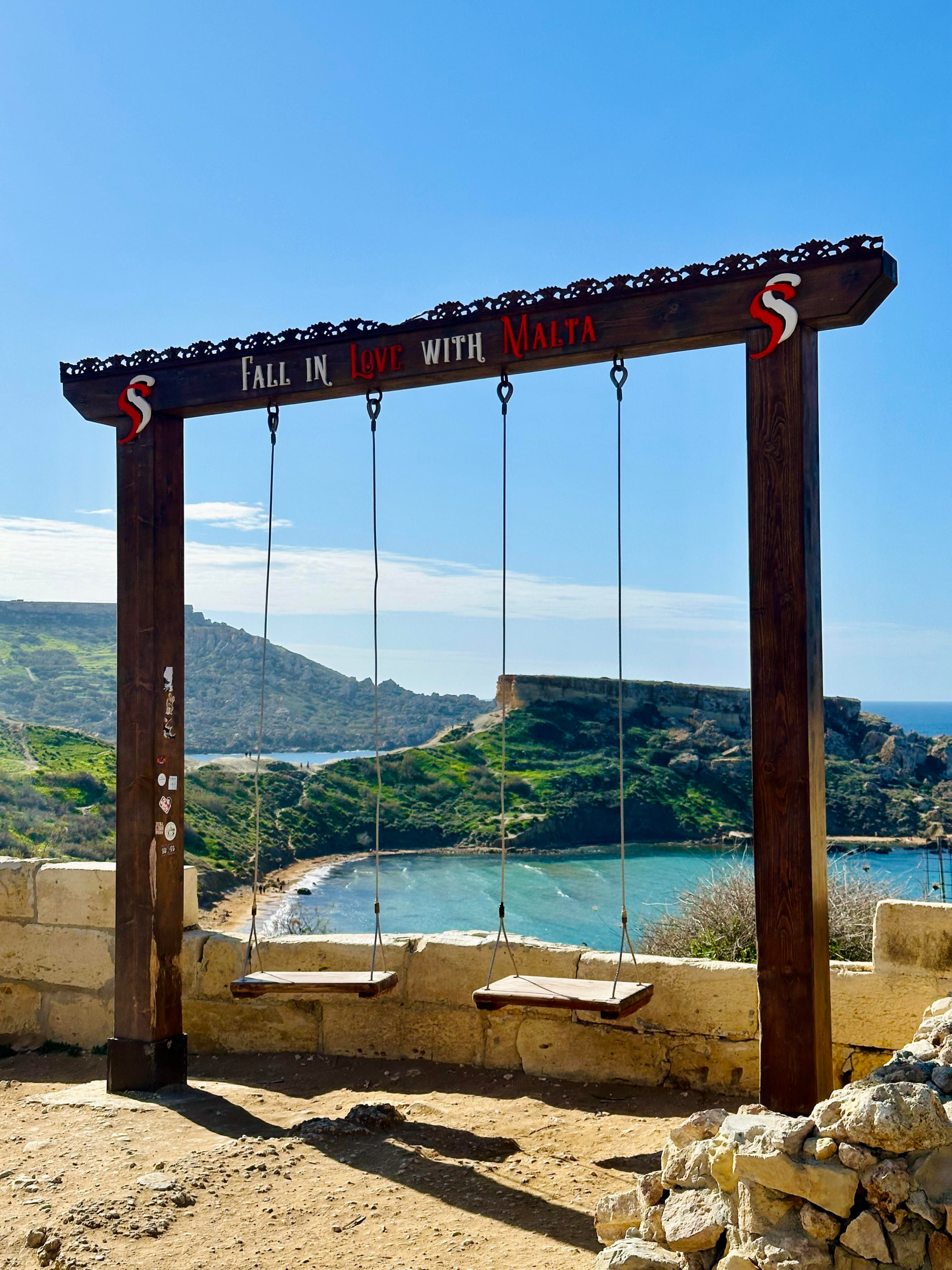Famous swings at Ghajn Tuffieha Beach Malta with ocean backdrop.