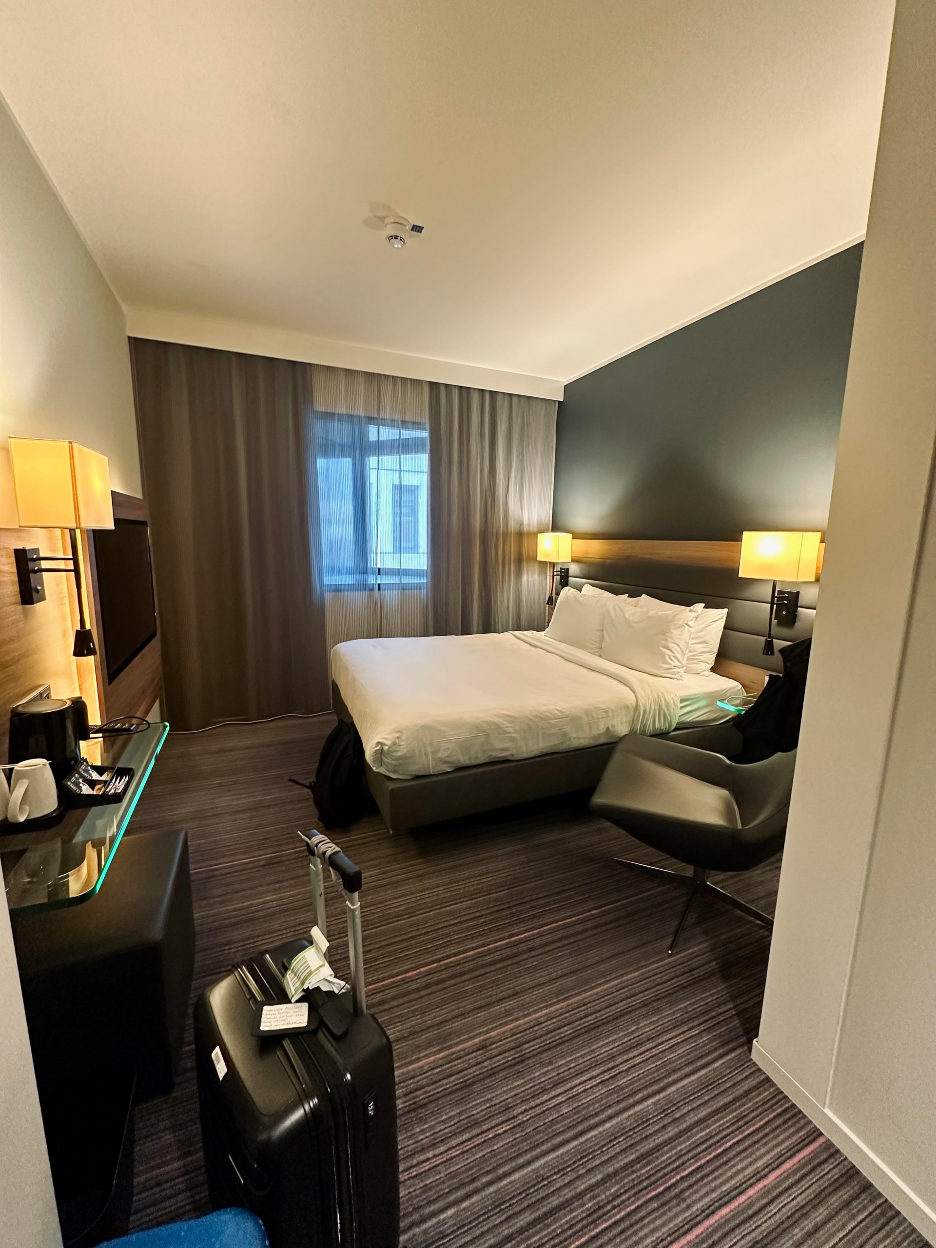 Stylish and comfortable hotel room at Moxy London Stratford with modern decor and cozy bedding