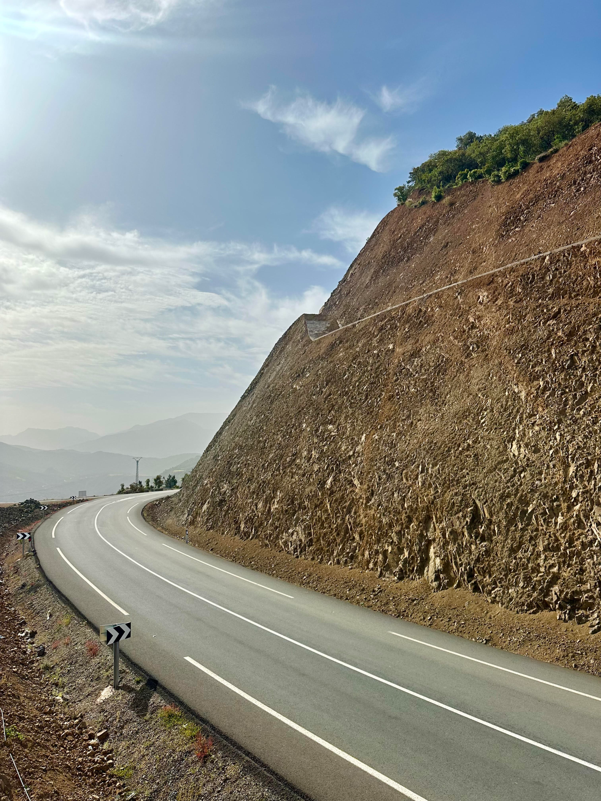 Scenic road through Morocco leading to the Sahara Desert with the Atlas Mountains in the background — featured image for my Morocco 9 Day Itinerary.