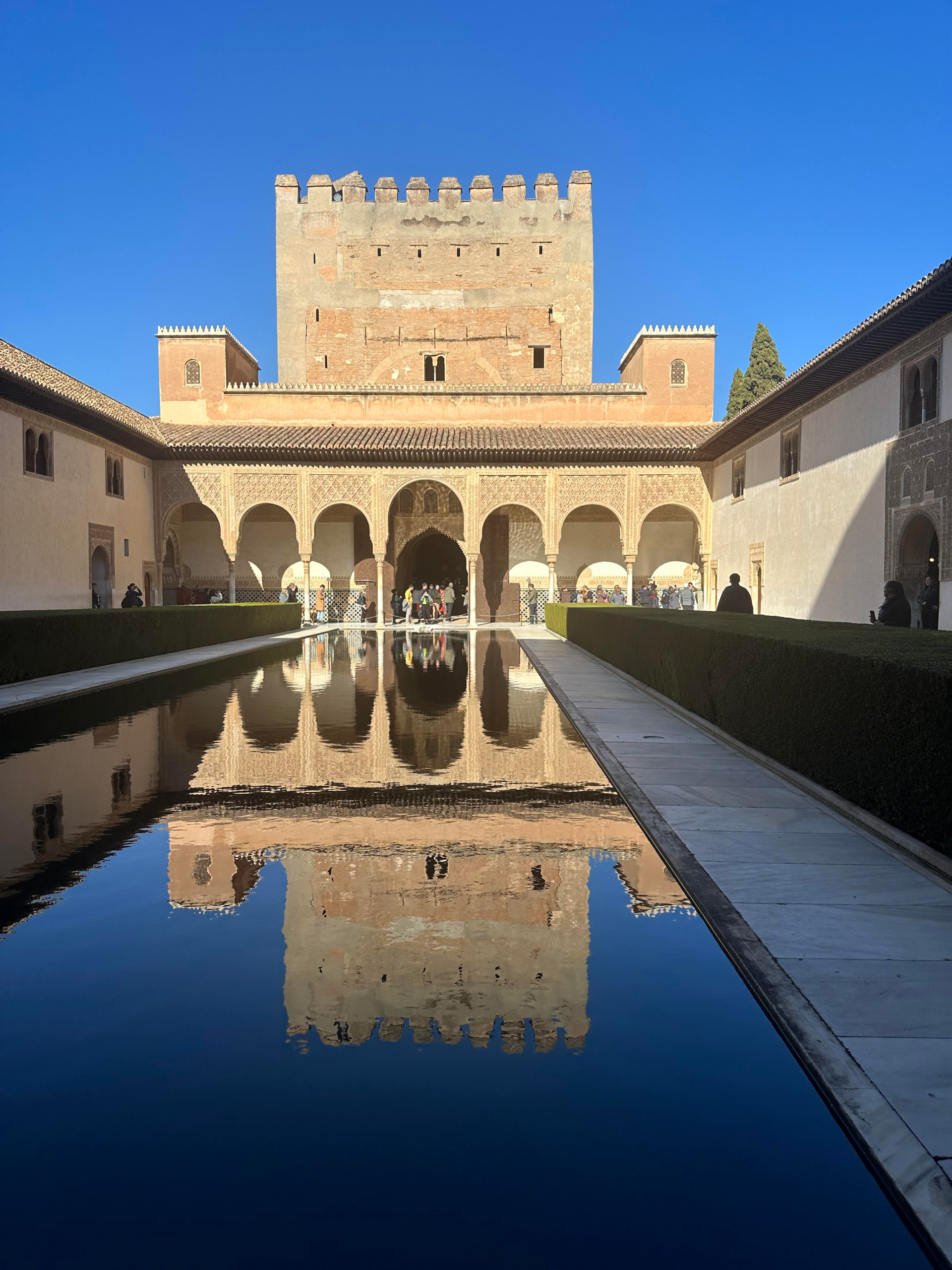 Ornate arches and detailed Moorish carvings in the Nasrid Palaces at the Alhambra, Granada, showcasing Islamic architecture and historic elegance.