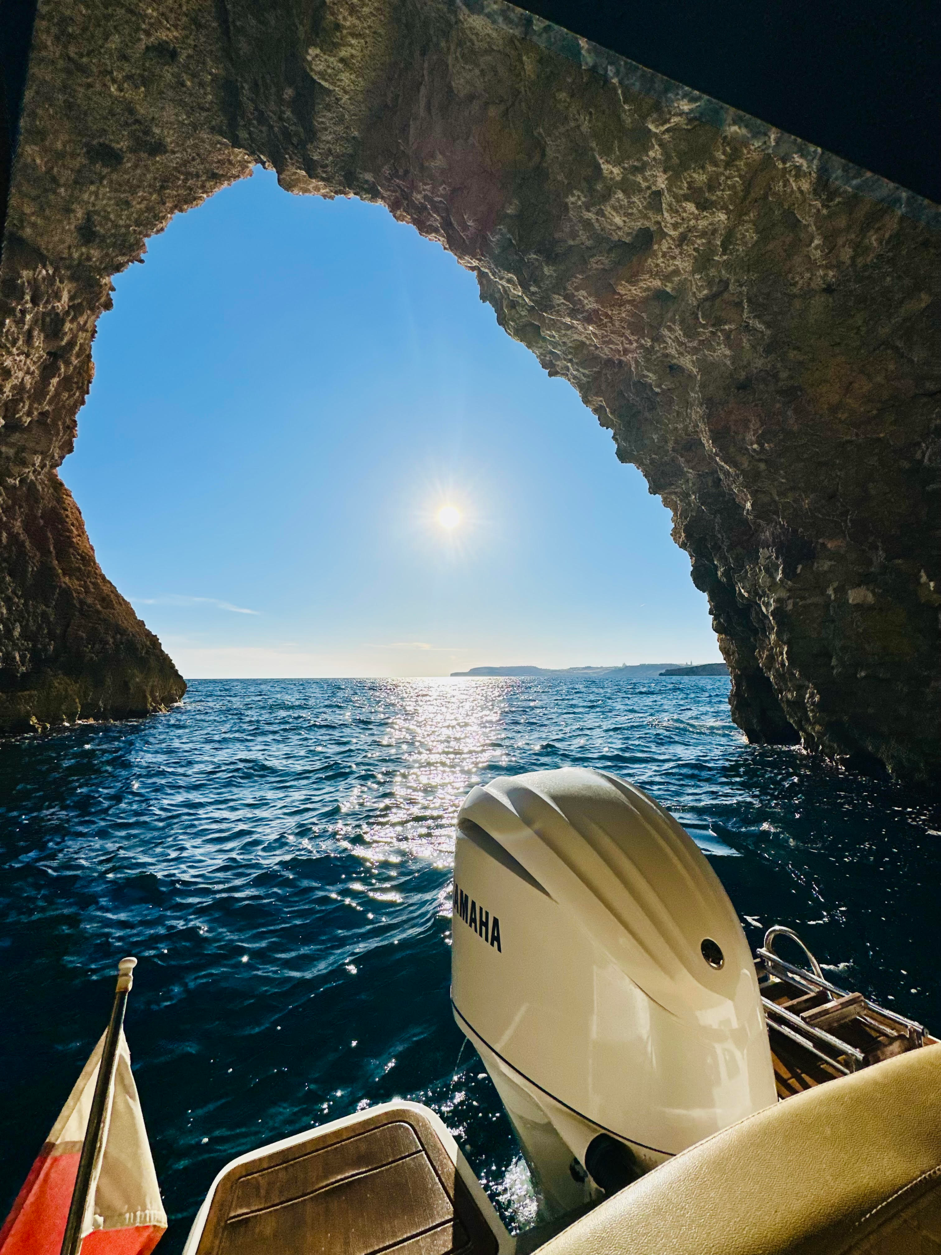 Exploring hidden sea caves around Comino by boa