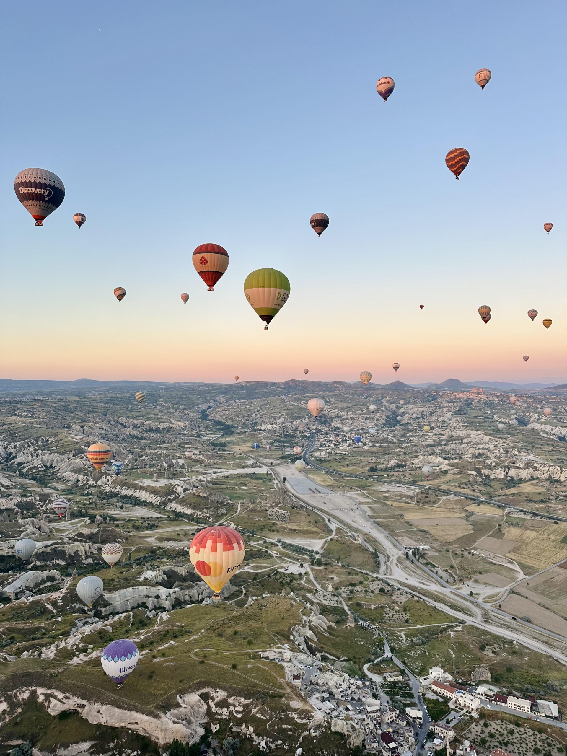 Sky full of colourful hot air balloons over Cappadocia at sunrise